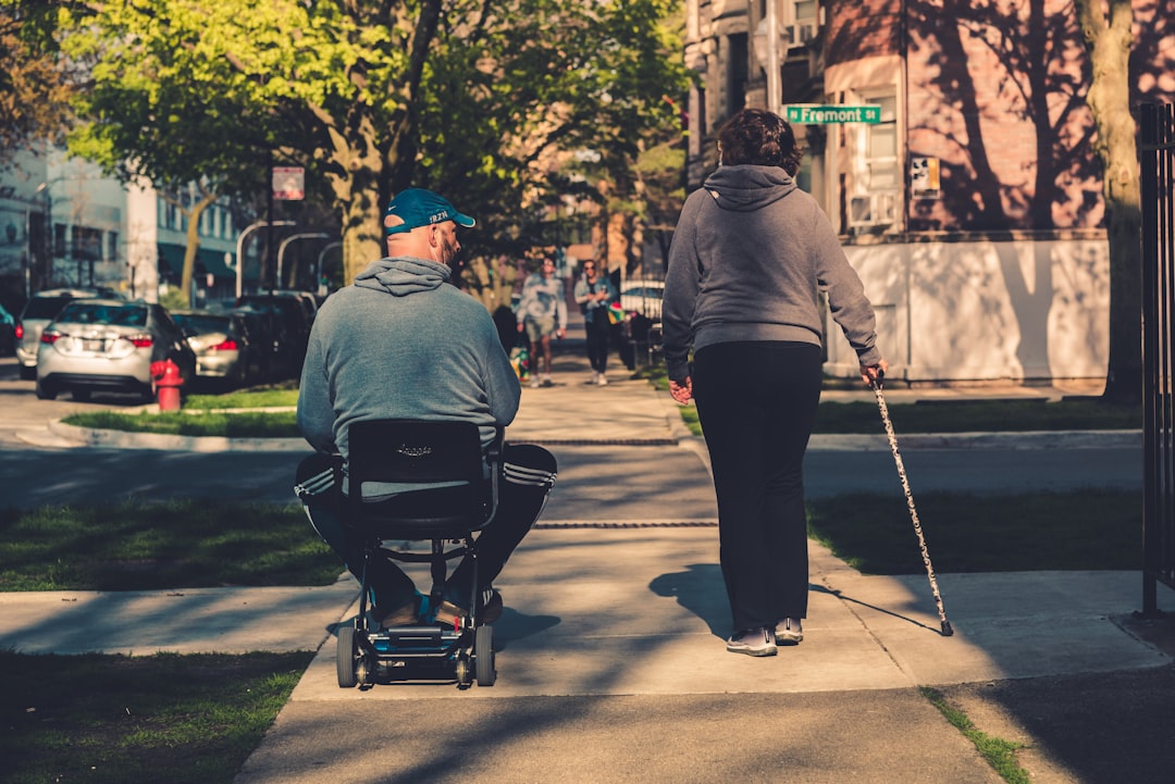A person using a mobility scooter exploring a scenic city street, showcasing accessibility in travel.