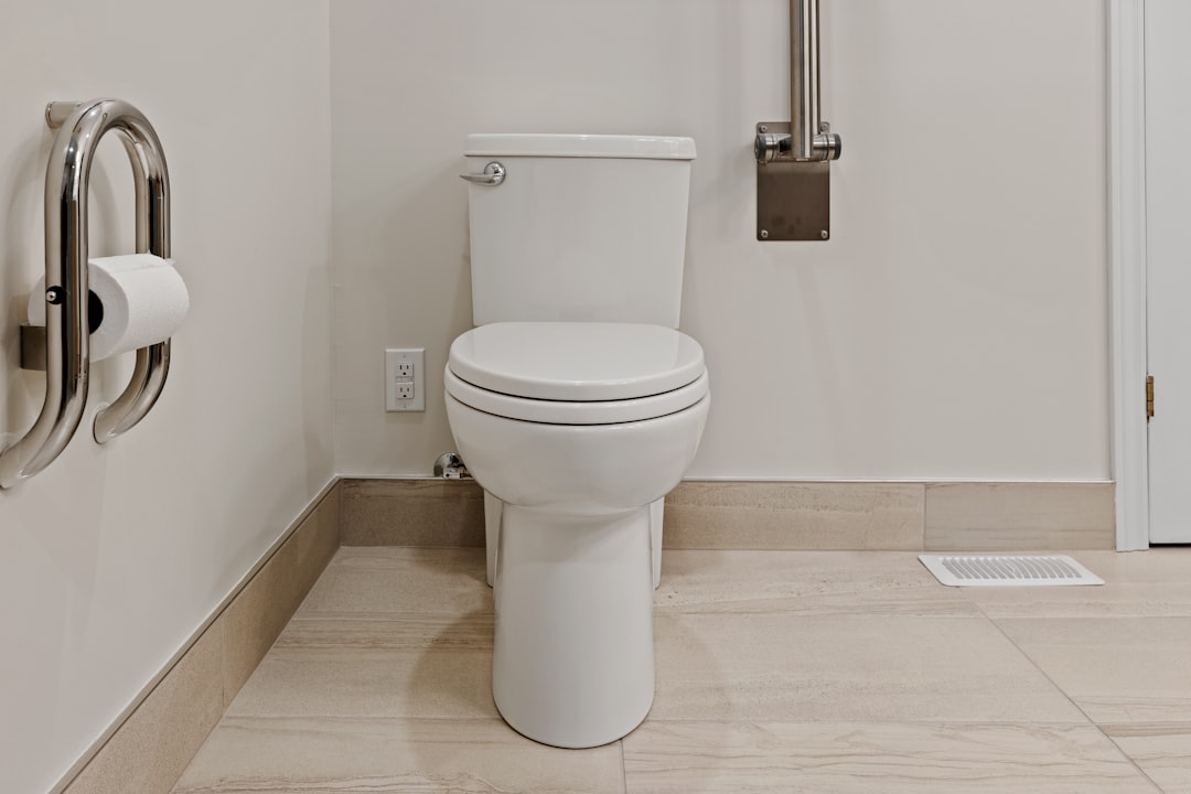 A well-designed accessible bathroom with grab bars and non-slip flooring, showcasing safety features for travelers with limited mobility.