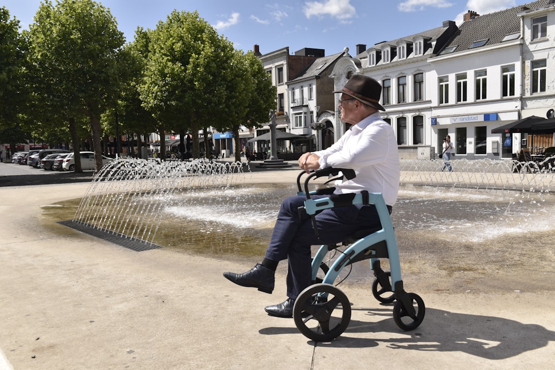 A person using a walker in a scenic travel destination, enjoying the view with a relaxed expression.