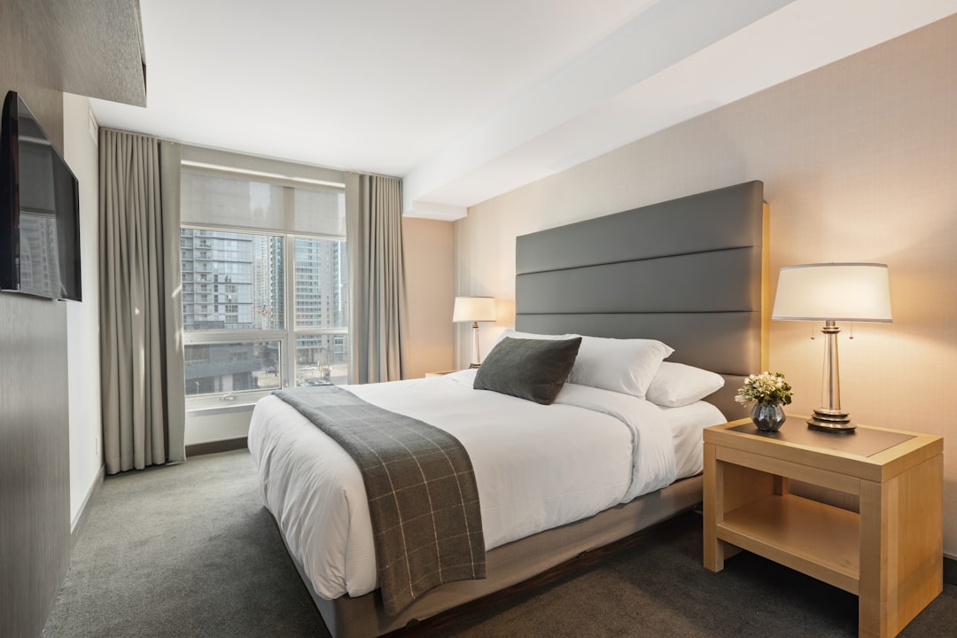 A comfortable and accessible hotel room with wide doorways, grab bars, and a spacious layout, showcasing a welcoming environment for travelers with disabilities.
